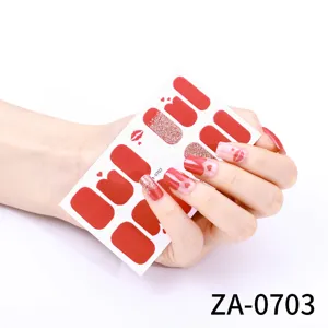Detailed view of red heart and lips nail wrap stickers, featuring glitter and stylish patterns.