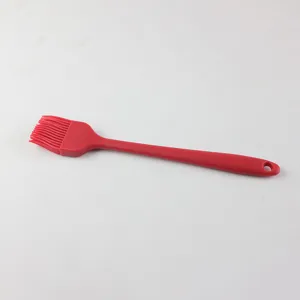 Red silicone oil brush detail view, flexible bristles for baking and cooking tasks clearly shown.