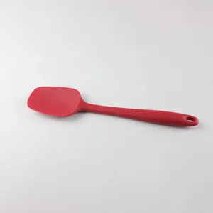 Red silicone spatula detail, flexible baking scraper tool for kitchen cooking and cake cream.
