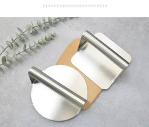 Stainless steel burger press set with wooden base, durable tool for meat patties and wrappers.
