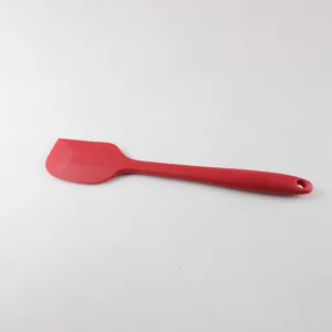 Red silicone spatula detail, flexible baking tool for cream mixing, heat resistant.