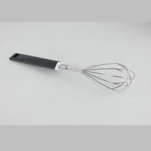 Stainless steel wire whisk detail, ergonomic grey plastic handle for kitchen baking use.