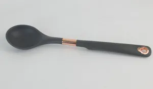 Silicone soup spoon with rose gold accent, kitchen cooking utensil detailed view.