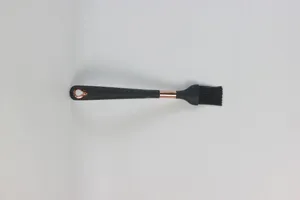 Detailed view of the black silicone pastry brush with elegant rose gold accents.