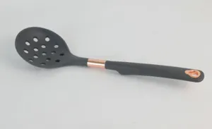 Close-up of dark grey silicone slotted spoon featuring a rose gold accent and hanging hole.