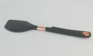 Detailed view of black silicone spatula with rose gold accents, heat resistant baking tool.