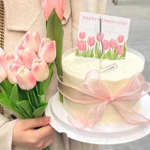 Mother's Day cake topper with card pink ribbon and tulip bouquet for celebration
