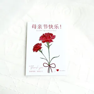 Close up detail of Mother Day carnation card cake topper with greeting text design.