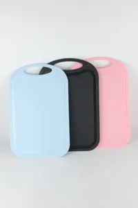 Close-up detail of anti-slip plastic cutting boards in blue, black and pink colors.