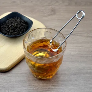 Stainless steel ball tea infuser with long clip handle, perfect for loose leaf tea brewing.