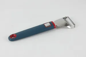 Stainless steel vegetable peeler detail showing sharp blade and ergonomic non-slip handle.