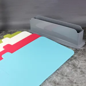 Detailed view of plastic cutting board set with storage rack, kitchen food preparation tool.