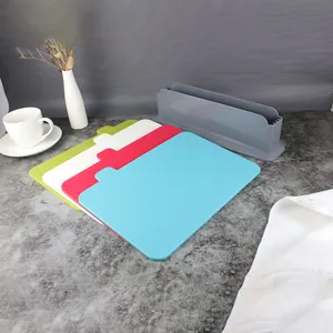 Plastic cutting board set detail view showing four colorful boards and gray storage holder stand.