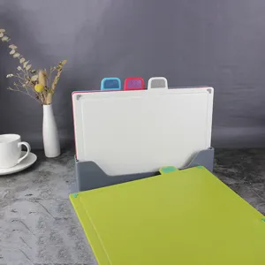 Close-up detail of plastic cutting board set with storage stand and classification icons.