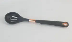 Dark grey silicone slotted cooking spoon with rose gold accent details for kitchen utility detail.