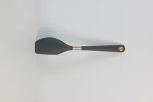 Silicone kitchen utensil detail shot featuring a black head with rose gold metallic accent ring.