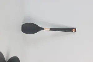 Black silicone cooking spoon with rose gold accent, non-stick kitchen utensil detail view.