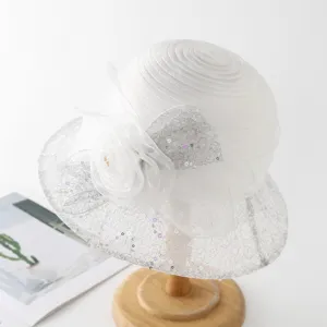 Detailed view of white organza sun hat, delicate lace and sequins for chic summer style.
