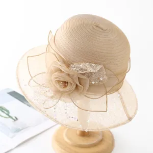 Detail of elegant organza lace sun hat, showing delicate floral applique and sequins.