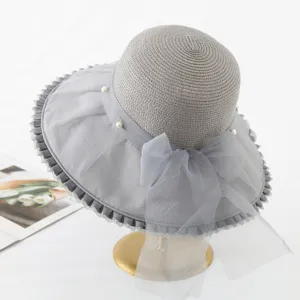 Detailed view of grey wide brim organza sun hat with elegant pearl and bow for women beach.