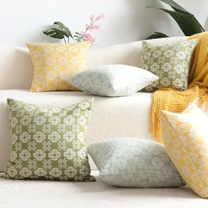 Closeup detail view of chic jacquard throw pillow covers featuring modern minimalist clover design.