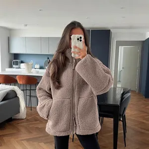 Cozy high neck teddy fleece jacket detail, soft sherpa material, zip up winter outerwear.