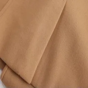Close-up detail of men's wool blend coat fabric, premium camel texture and neat edge stitching.