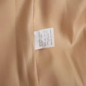 Coat inner wash label detail showing material composition and manufacturing information.
