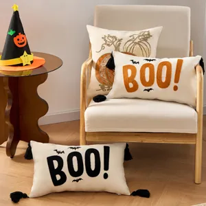 Halloween decorative pillow cover with bat pumpkin embroidery and tassels, cozy home decor.