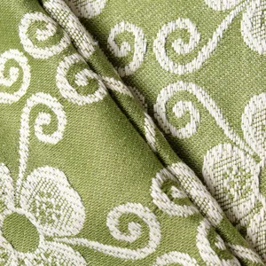 Green woven jacquard pillow cover fabric close-up showcasing clover texture design.
