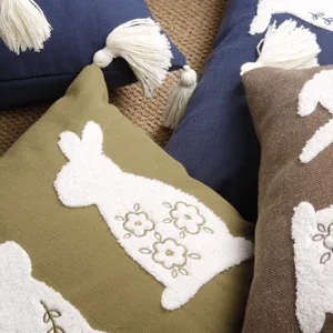 Easter bunny throw pillow cover with towel embroidery and tassels, cotton linen cushion detail.