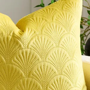 Close-up detail of soft yellow velvet cushion cover featuring elegant embossed ginkgo leaf pattern.