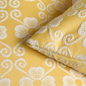 Yellow jacquard throw pillow cover detail showcasing elegant clover floral pattern texture.