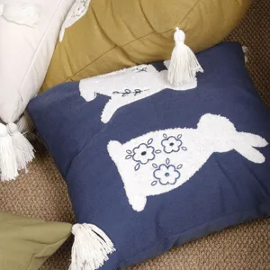Easter bunny throw pillow cover with cute tufted rabbit and tassels for spring decor.