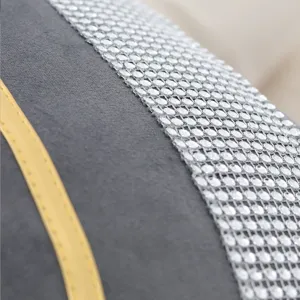 Detail close-up view of elegant velvet cushion cover featuring rhinestone trim and gold piping.