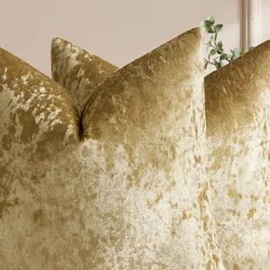 Close-up view of luxury golden crushed velvet pillow cover, highlighting soft textured cushion.