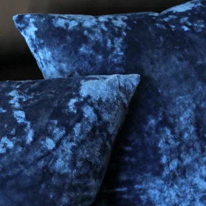 Close-up detail of luxury blue velvet pillowcase, soft plush fabric texture for sofa decor.