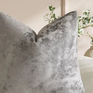 Grey crushed velvet pillow cover close up showing soft fabric texture and luxury living decor.