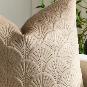 Close-up view of beige velvet throw pillow cover featuring elegant quilted ginkgo leaf pattern texture