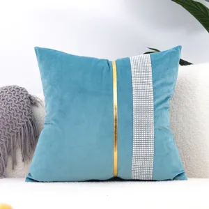 Elegant blue velvet cushion cover featuring striking gold and rhinestone decorative strips detail.