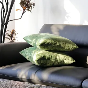 Green velvet throw pillow cover detail view, soft luxury sofa cushion for modern home decor.