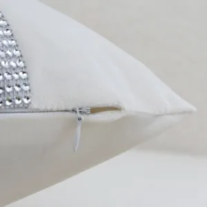 White velvet cushion cover detail showcasing zipper and rhinestone trim, soft and elegant.