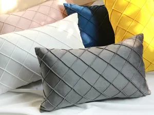 Close-up detail of Nordic velvet diamond pinch-pleat throw pillow covers in various colors.