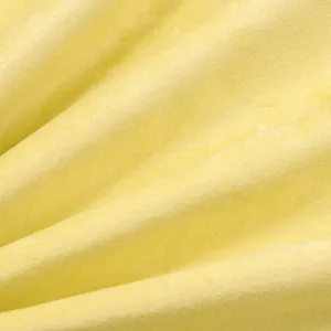 Yellow velvet cushion cover fabric texture detail close up view soft material surface