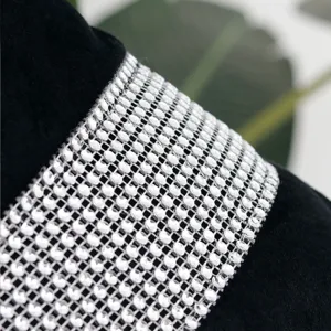 Velvet cushion cover detail featuring sparkling rhinestone mesh trim for elegant home decor.