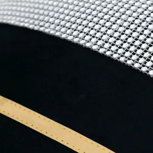 Black velvet pillow cover detail with sparkling rhinestone mesh trim and modern gold stripe design.