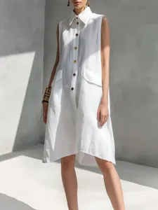 Close-up detail of white sleeveless lapel dress featuring front button closure and side pockets.