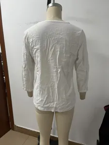Back detail view of women's solid color 3/4 sleeve casual top in breathable fabric.