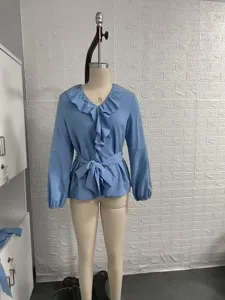 Light blue long sleeve V-neck blouse with double ruffle collar and waist tie detail.