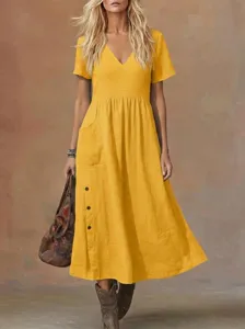 Detail view of casual yellow v-neck short sleeve loose dress with side pocket buttons.